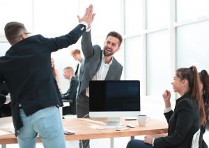 young employees giving each other a high five